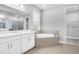 Luxurious bathroom featuring a soaking tub, walk-in shower, dual vanity, and recessed lighting at 2982 Arranmore Dr, Ormond Beach, FL 32174
