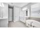Elegant bathroom featuring a soaking tub, double vanity, stylish mirror, and ample storage space at 2982 Arranmore Dr, Ormond Beach, FL 32174