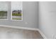 Bedroom with two windows, offering great light and views, and hardwood flooring at 2982 Arranmore Dr, Ormond Beach, FL 32174