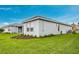 Side view showcases a manicured lawn, professional landscaping, and home exterior at 2982 Arranmore Dr, Ormond Beach, FL 32174