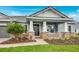Close up of the charming single-story home with a covered front porch, and manicured front lawn at 2982 Arranmore Dr, Ormond Beach, FL 32174