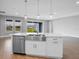 Kitchen island with stainless steel sink, white cabinetry, and view of the backyard at 2982 Arranmore Dr, Ormond Beach, FL 32174