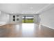 Bright living room with access to outdoor views through sliding glass doors and wood-look flooring at 2982 Arranmore Dr, Ormond Beach, FL 32174
