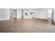 Open-concept living space with wood-look floors and a view of the kitchen at 2982 Arranmore Dr, Ormond Beach, FL 32174