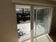 View of backyard through sliding glass door with patio and fenced yard at 451 Lowndes Sq, Casselberry, FL 32707