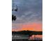 Picturesque sunset over the water with a silhouette of a dock in the foreground at 1043 Lemon Bluff Rd, Osteen, FL 32764