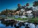 Stunning view of a waterfront estate with multiple docks, mature palms, and a well-manicured lawn at 1043 Lemon Bluff Rd, Osteen, FL 32764