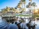 Lovely waterfront home with a dock and beautiful water views under a bright sky at 1043 Lemon Bluff Rd, Osteen, FL 32764