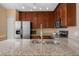 This kitchen features granite countertops, stainless steel appliances, and dark wood cabinets at 1054 Waterside Dr, Celebration, FL 34747