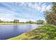 Scenic water view of a lake, golf course, and walking path under a beautiful blue sky at 1054 Waterside Dr, Celebration, FL 34747