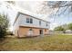 View of the backyard featuring a sliding glass door and a concrete patio at 2824 Corrigan Dr, Deltona, FL 32738