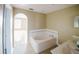 Bathroom with corner tub and a door leading to a secondary space at 2824 Corrigan Dr, Deltona, FL 32738