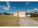 Inviting two-story home featuring a large front yard and an attached two car garage at 2824 Corrigan Dr, Deltona, FL 32738
