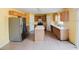 Kitchen featuring an island, tile flooring, stainless steel refrigerator and wood cabinetry at 2824 Corrigan Dr, Deltona, FL 32738