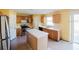 Kitchen featuring an island, tile flooring, stainless steel appliances and wood cabinetry at 2824 Corrigan Dr, Deltona, FL 32738
