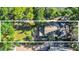 Aerial view of the property showing lush landscaping, backyard with patio, and the home's roof at 786 Antonette Ave, Winter Park, FL 32789