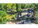 Aerial view of the property showing lush landscaping, backyard with patio, and the home's roof at 786 Antonette Ave, Winter Park, FL 32789