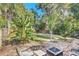 Inviting backyard with lush greenery, brick patio, and fire pit, perfect for outdoor relaxation at 786 Antonette Ave, Winter Park, FL 32789