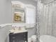 Charming bathroom with an ornate mirror, claw foot tub, and blue patterned shower curtain at 786 Antonette Ave, Winter Park, FL 32789