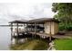 Boat dock and lift on the water with boat and lakeside shed offering a waterfront retreat and boat storage at 786 Antonette Ave, Winter Park, FL 32789