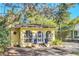 Charming yellow home with arched windows, landscaped entryway, and inviting curb appeal at 786 Antonette Ave, Winter Park, FL 32789