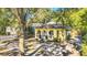 Charming yellow house with arched windows, nestled among mature trees and lush landscaping at 786 Antonette Ave, Winter Park, FL 32789