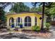 Charming yellow house with arched windows and a well-manicured front yard at 786 Antonette Ave, Winter Park, FL 32789