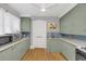 Bright kitchen with blue tile backsplash, wood floors, updated cabinets, and a stainless steel sink at 786 Antonette Ave, Winter Park, FL 32789