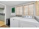 Bright laundry room with modern washer and dryer, ample counter space, and natural light at 786 Antonette Ave, Winter Park, FL 32789