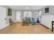 Inviting living room with hardwood floors, a cozy couch, and a decorative white fireplace at 786 Antonette Ave, Winter Park, FL 32789