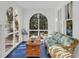 Cozy sunroom featuring arched windows, a wicker couch, and unique decorative accents at 786 Antonette Ave, Winter Park, FL 32789