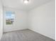 Bright bedroom with gray carpet and window at 16320 Happy Eagle Dr, Clermont, FL 34714