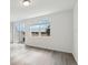 Living room with vinyl plank flooring, large window, and sliding glass doors at 16320 Happy Eagle Dr, Clermont, FL 34714