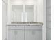 Bright bathroom features a dual sink vanity with granite counters and ample storage space at 16332 Happy Eagle Dr, Clermont, FL 34714