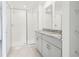 Bright bathroom showcasing granite counters, dual sinks, and glass enclosed shower at 16332 Happy Eagle Dr, Clermont, FL 34714