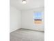 A bright bedroom offers a peaceful retreat with soft carpet and a serene view from the window at 16332 Happy Eagle Dr, Clermont, FL 34714