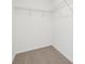Walk-in closet featuring carpeted flooring and wire shelving unit at 16332 Happy Eagle Dr, Clermont, FL 34714