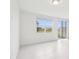 An airy room features a window and sliding door that brings in ample natural light at 16332 Happy Eagle Dr, Clermont, FL 34714