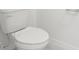 Close-up of a pristine white toilet with classic design, complemented by clean, white walls at 16332 Happy Eagle Dr, Clermont, FL 34714