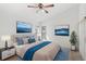 Beige bedding, blue accents, and ocean-themed art at 230 Bay Meadow Dr, Kissimmee, FL 34746