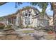 Tan house with white garage door and landscaping at 230 Bay Meadow Dr, Kissimmee, FL 34746