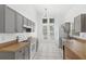 Gray cabinets, white appliances, and light tile floors at 230 Bay Meadow Dr, Kissimmee, FL 34746