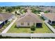 Aerial perspective of the backyard featuring a white fence, well-kept lawn, and a screened-in patio at 236 Barrington Dr, Haines City, FL 33844