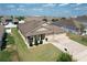 Aerial view of a well-kept single-story home with a three-car garage, and a lush green lawn at 236 Barrington Dr, Haines City, FL 33844