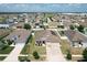 Wide aerial view of a neighborhood featuring well-maintained homes with lawns, trees and a lush green landscape at 236 Barrington Dr, Haines City, FL 33844