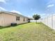 Large, well-manicured backyard with a white fence, providing privacy and a serene outdoor space at 236 Barrington Dr, Haines City, FL 33844