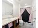 Bathroom with white walls, tile floors, vanity, and a shower with a patterned curtain at 236 Barrington Dr, Haines City, FL 33844