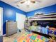 bedroom showcasing a bunk bed, dresser, colorful rug, and tile floors at 236 Barrington Dr, Haines City, FL 33844