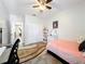 Bedroom featuring neutral walls, tile floors, a bed, a dresser, and a desk at 236 Barrington Dr, Haines City, FL 33844