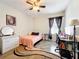 Bedroom featuring neutral walls, tile floors, a ceiling fan, and a bed with a desk at 236 Barrington Dr, Haines City, FL 33844